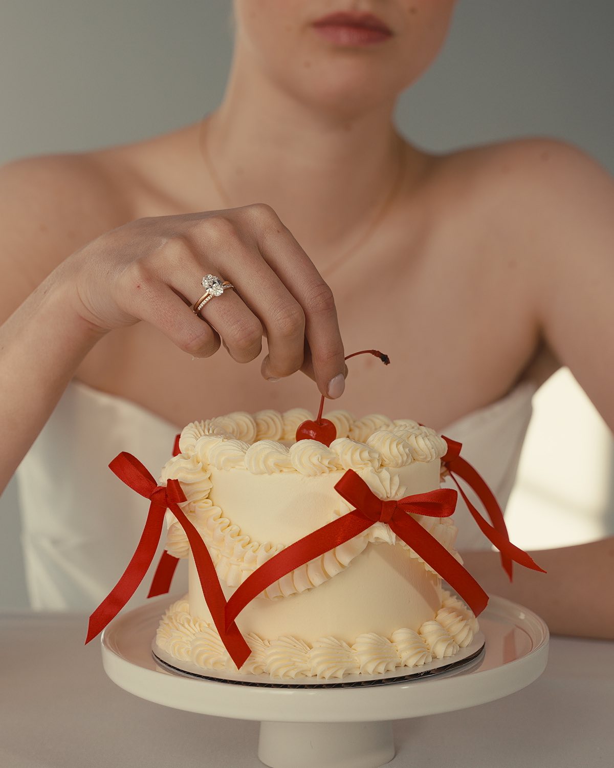 A Macor ad frame: a model reaching for the cherry on a bowed cake