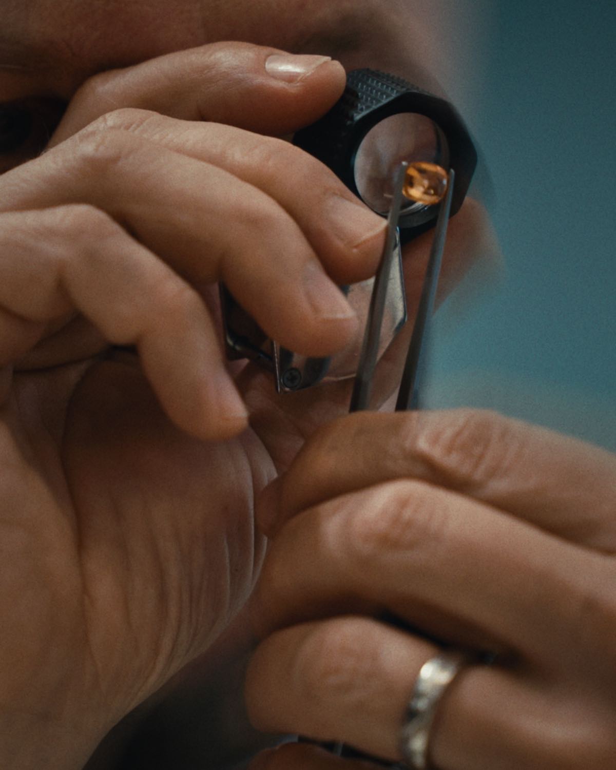 A goldsmith checking a gemstone through a loupe, from the Kulmala content library