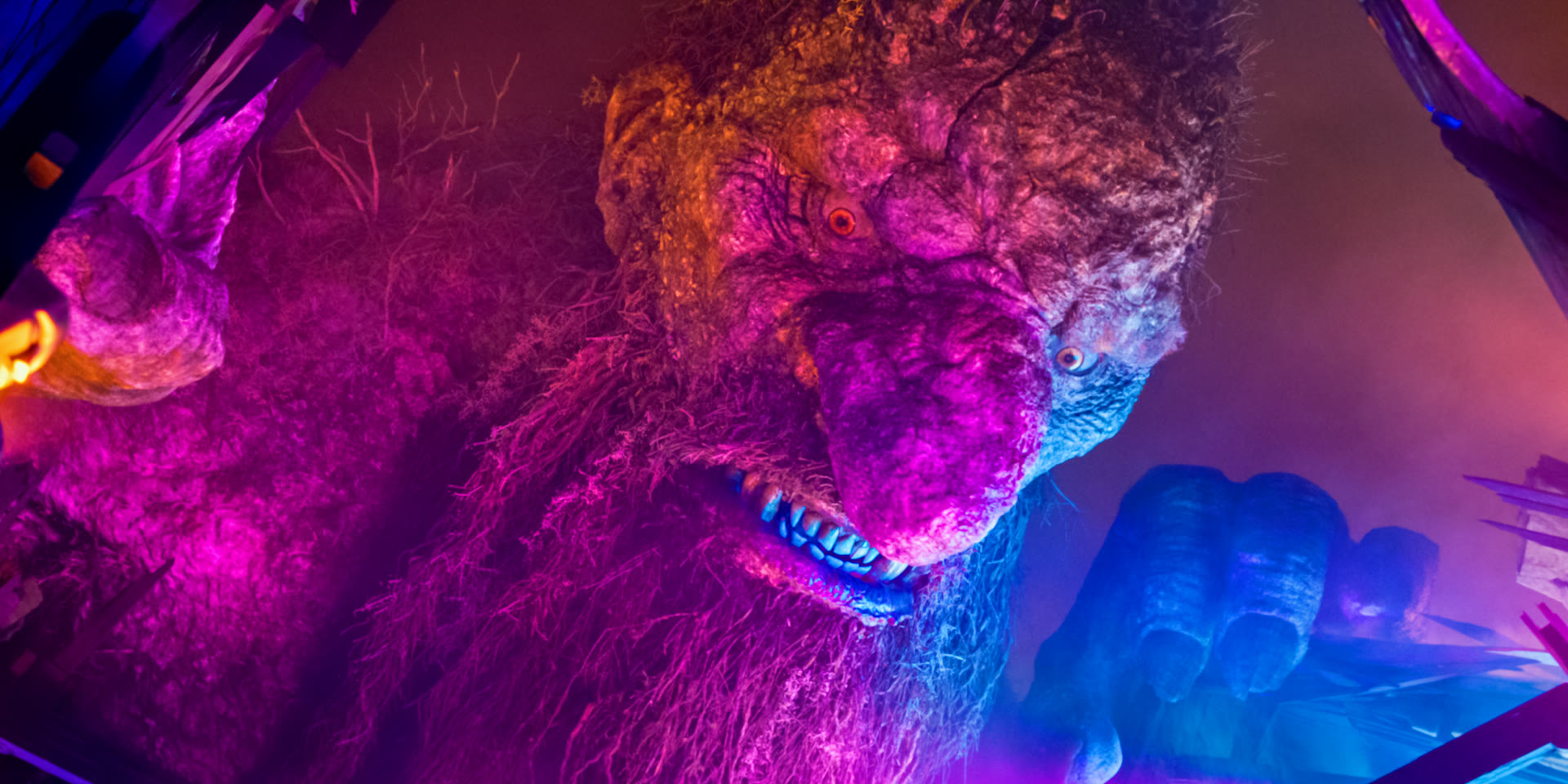 Troll 2 film still: a troll lit in neon pink and blue above a city street