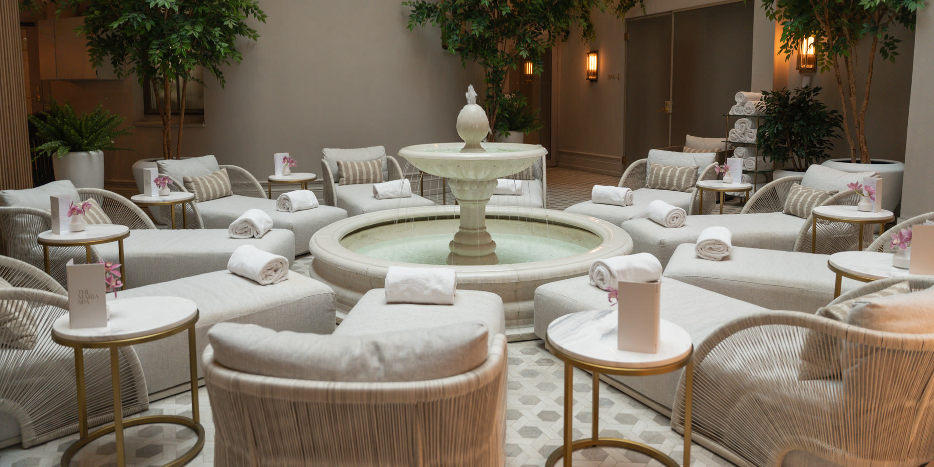 The Waldorf Astoria Spa atrium, fountain and loungers under the glass roof